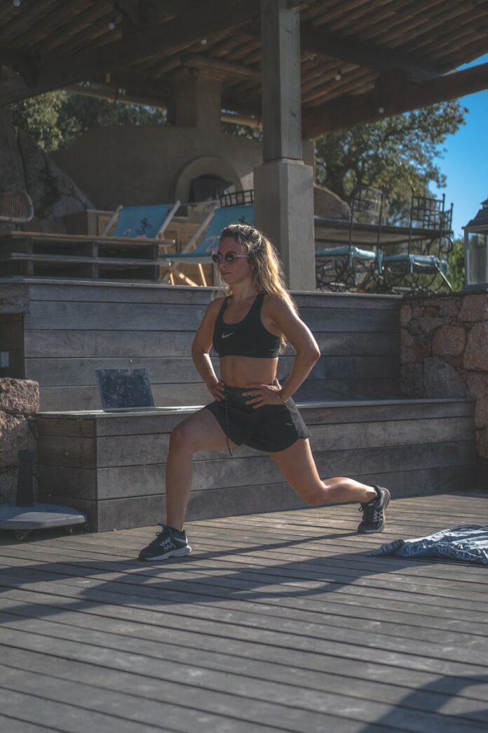 Photo by Big Dodzy woman in black sports bra and black shorts sitting on concrete bench during daytime