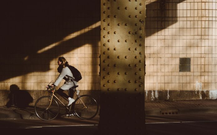 Photo by Marc Kleen person biking under highway