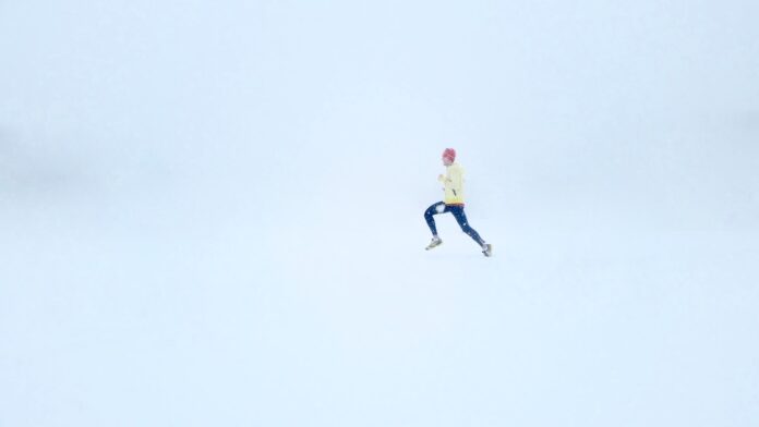 Photo by Isaac Wendland person wearing yellow jacket and black pants