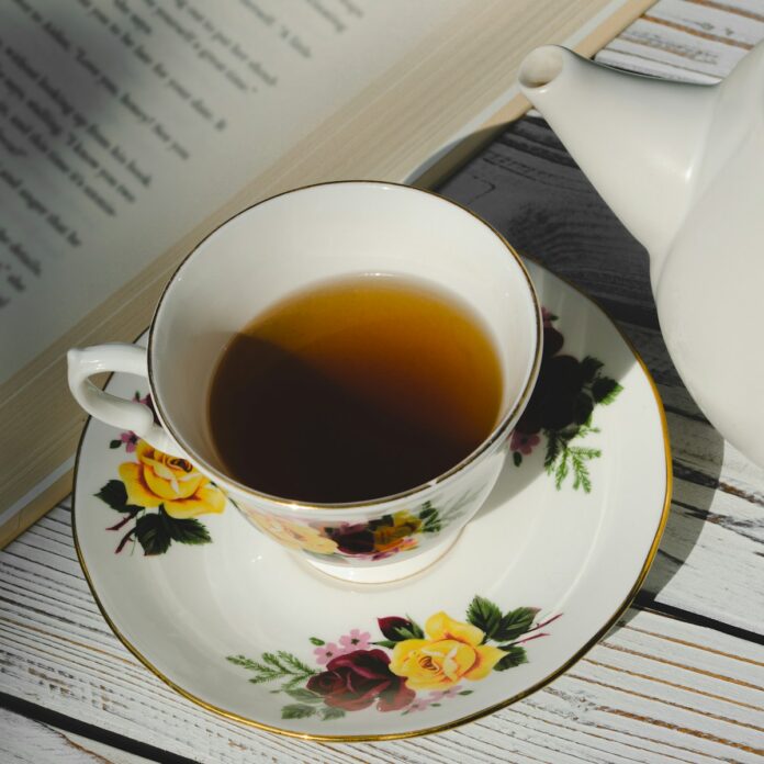 Photo by Megan Lee white ceramic teacup on white and pink floral ceramic saucer