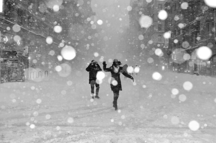 Photo by Jeffrey Blum people walking on snow covered street with bokeh effects photo