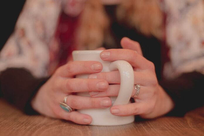 Photo by Dayne Topkin person holding white ceramic mug