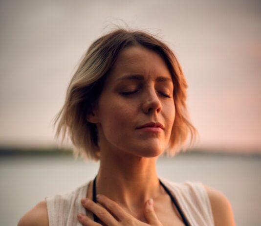 스트레스 관리, 마음 챙김으로 시작해보세요 woman in white vest and black bikini with hand on chest