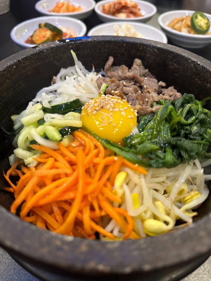 Photo by Dmitry Pavlovsky Korean bibimbap with side dishes is served.
