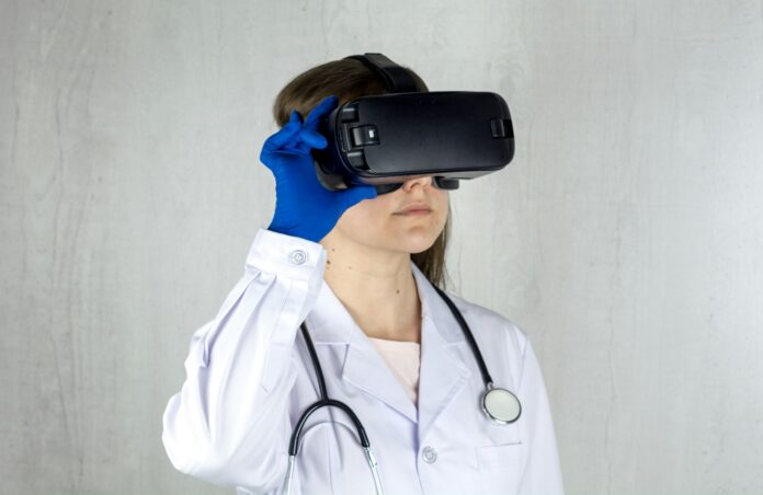 Photo by Bermix Studio a woman in a white coat and blue gloves is wearing a virtual headset