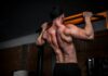 근육 건강, 일상 속 작은 실천이 만든다 topless man in black shorts holding orange bar